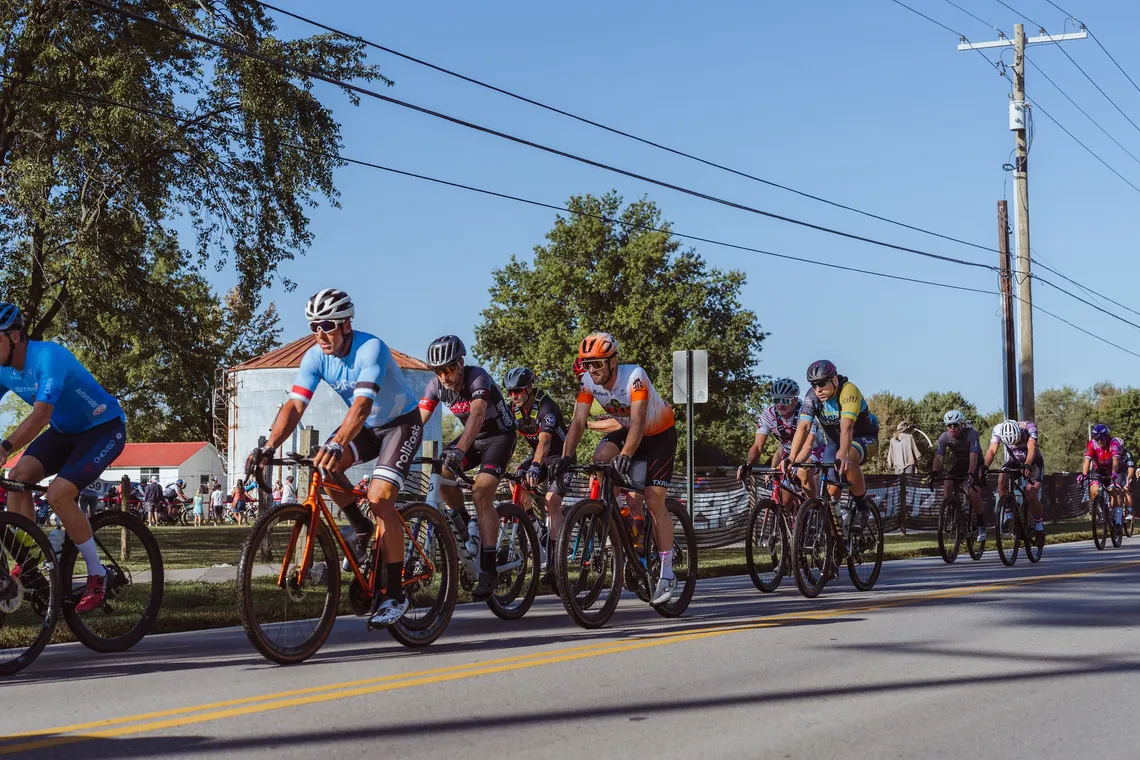A pack of riders rolling out through town