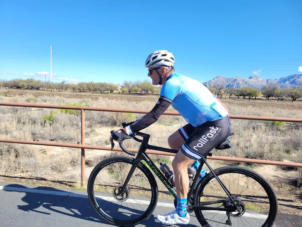 A Rollfast rider climbing on a desert road in Tucson